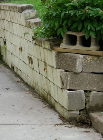 collapsing retaining wall with severe damage in Plymouth