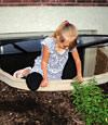 A child crawling out of an egress entryway window system in Colchester.