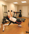a basement gym and workout room with a wood laminate flooring, installed in Essex Junction, VT and NH