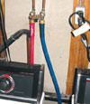 Side view of our washing machine hoses installed