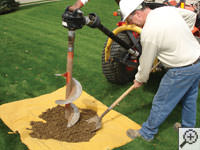 Auguring a hole in the earth for a foundation repair in Montpelier