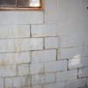 A cracked foundation wall near a window in a White River Junction home