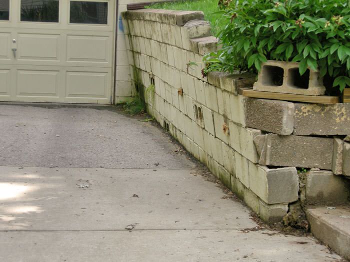 a failing retaining wall around a driveway in Burlington