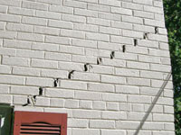 Stair-step cracks showing in a home foundation in Saint Johnsbury