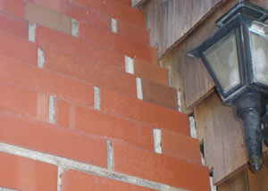 a repaired chimney in Claremont that had shown serious foundation damage and was repaired with a helical pier system.