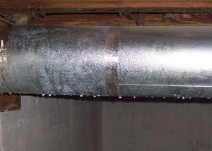 condensation collecting on an HVAC vent in a humid Montpelier basement