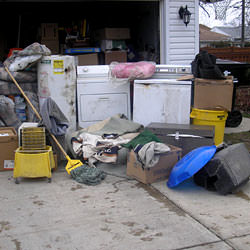 Soaked, wet personal items sitting in a driveway, including a washer and dryer in Plattsburgh, NY.