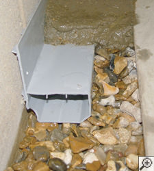 A no-clog basement french drain system installed in South Burlington