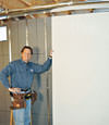 Installing wall panels on top of our basement wall insulation in Plattsburgh, NY